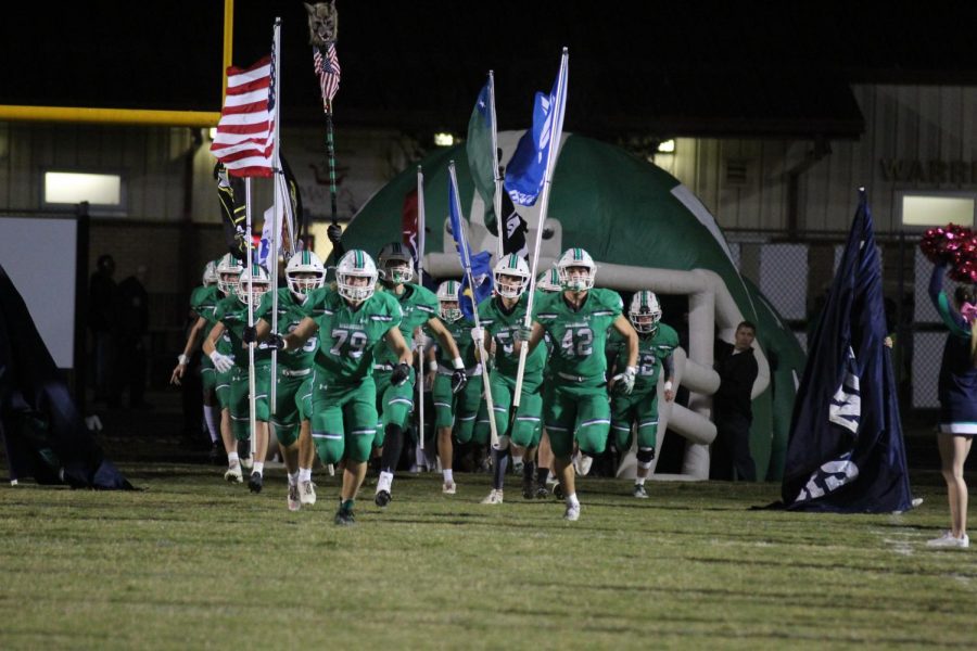 The Weddington Warriors storm the field as they prepare to take on the Parkwood Rebels. The Warriors went on to win the game 45-3.