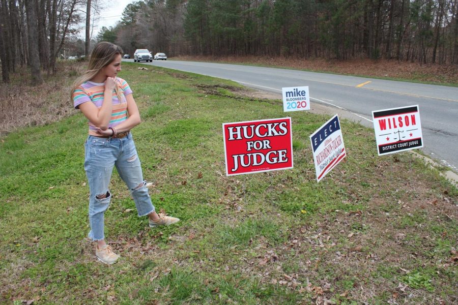 Senior Anna Hallmark contemplates campaign posters in preparation of super tuesday. To find your polling place go to https://vt.ncsbe.gov/PPLkup/.
