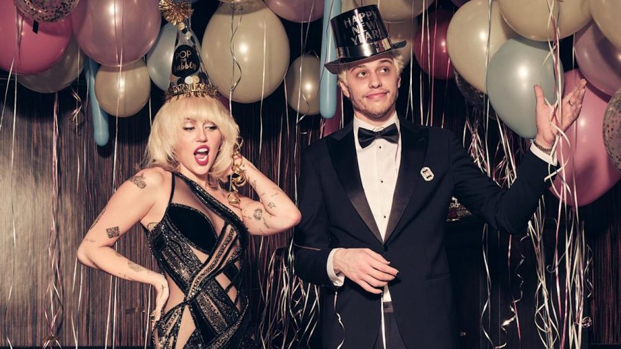 Miley Cyrus, left, and Pete Davidson, right, hosting the 2022 New Years Bash; which sparked controversy between Kim Kardashian and Miley Cyrus. Photo courtesy of Yahoo News.