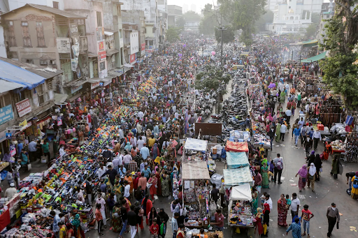A bustling crowd in a market area in Ahmedabad, India. Credit: Ajit Solanki/AP